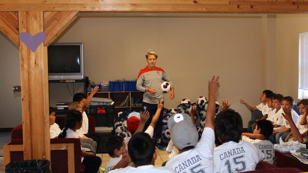 Lori Lindsey speaking to youth soccer players in Behchoko. Courtesy of U.S. Consulate Calgary