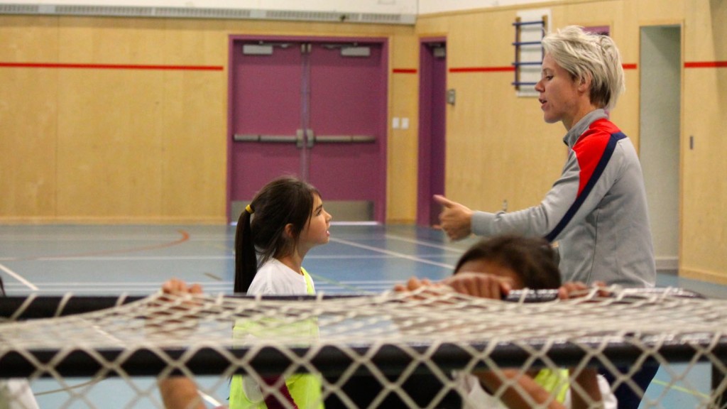 Lori Lindsey sharing advice with a girl during a clinic in Fort Providence. Courtesy of U.S. Consulate Calgary